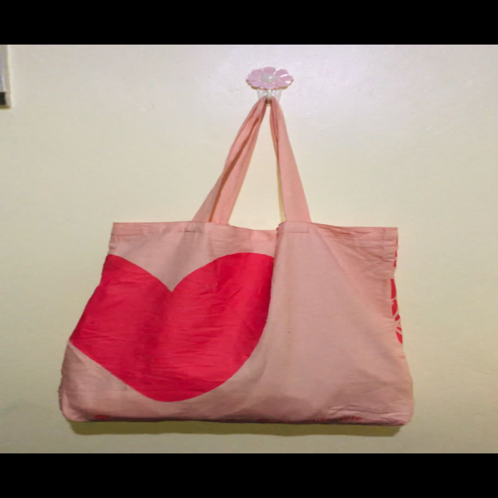 "The stylish pink tote bag available at Business2Commerce is a perfect example of affordable fashion. Made from high-quality cotton material, this tote bag features charming love heart prints and offers a wide storage space