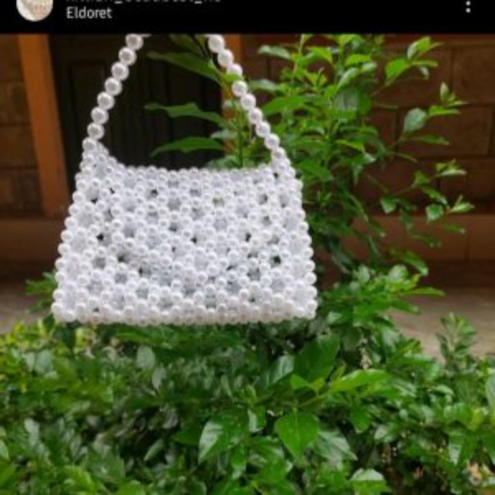 A customized triangular shaped pearl beaded bag.